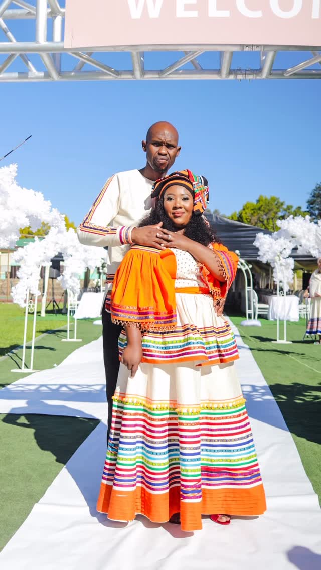 Couple in traditional Sepedi attire at a welcome arch